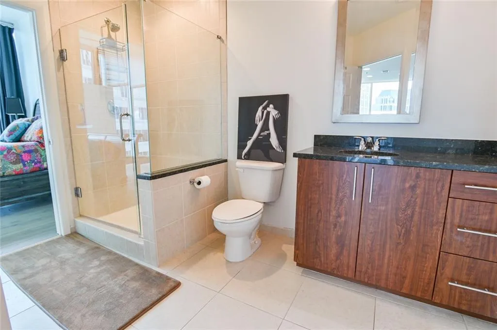Bathroom with vanity, tile patterned floors, and a stall shower