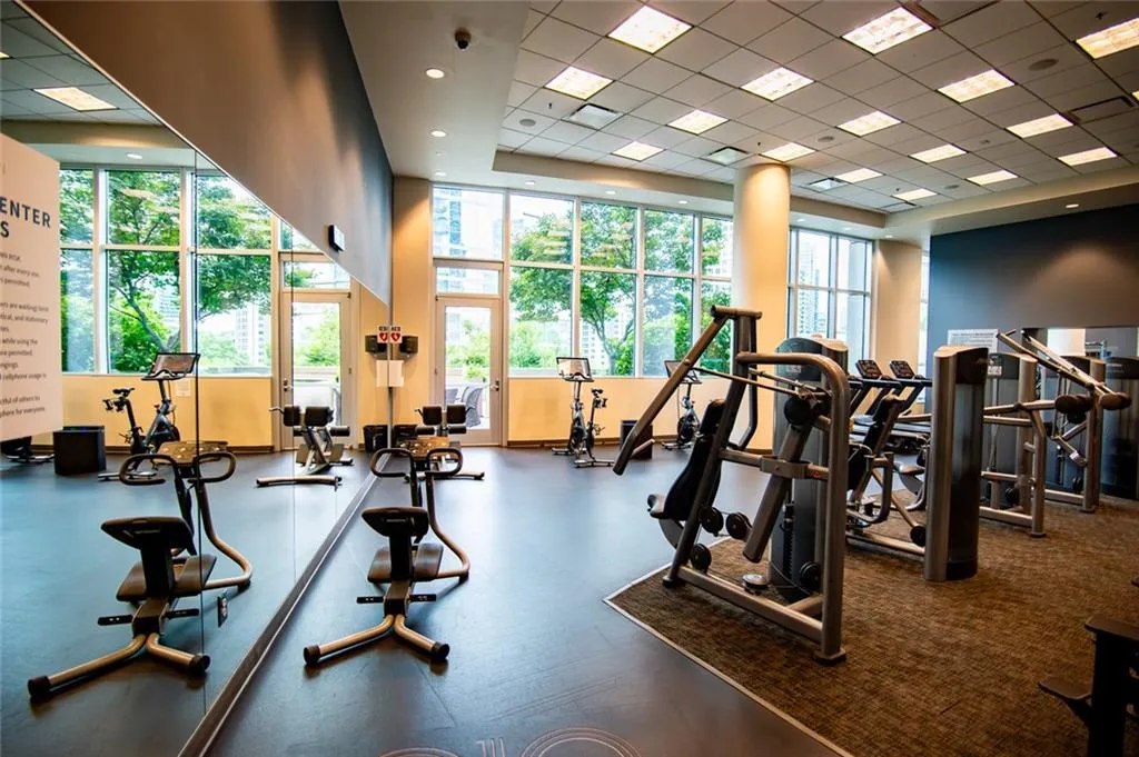 Workout area featuring a paneled ceiling and a high ceiling