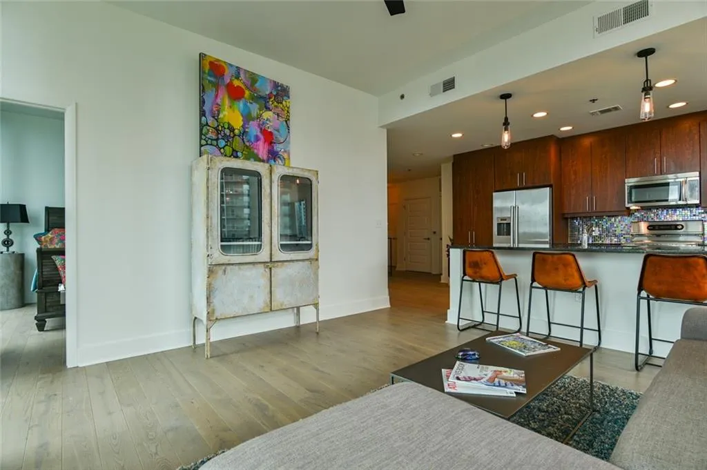 Living area with wood finished floors and recessed lighting