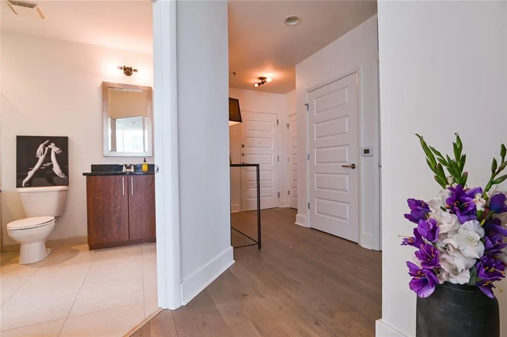 Hall with wood finished floors and baseboards