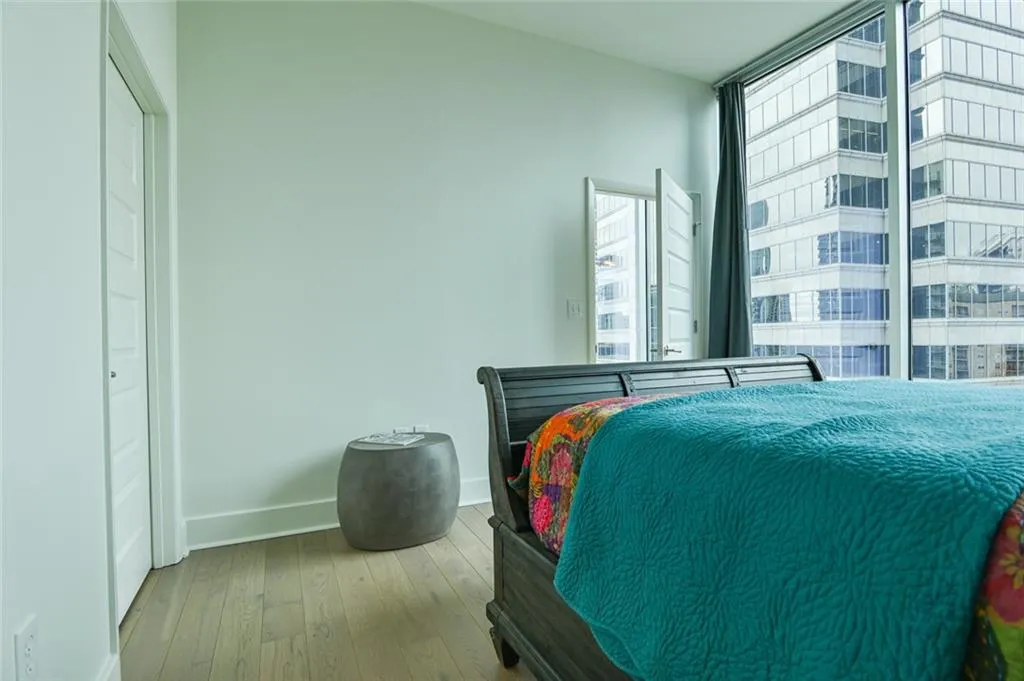 Bedroom with wood-type flooring and baseboards