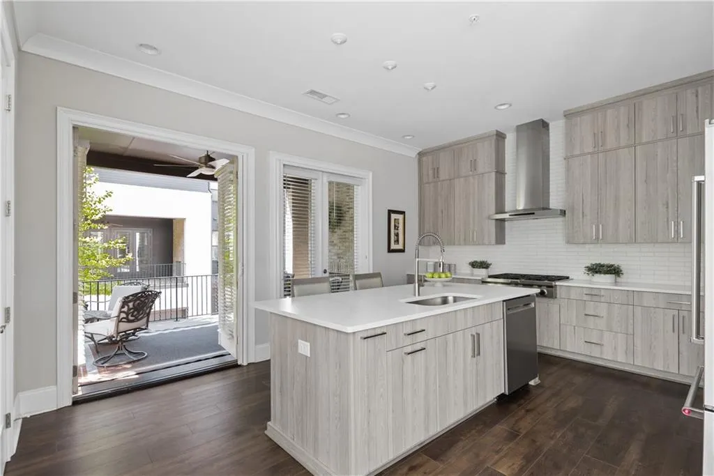 Two sets of french doors open to a covered patio and fireplace - perfect for entertaining!
