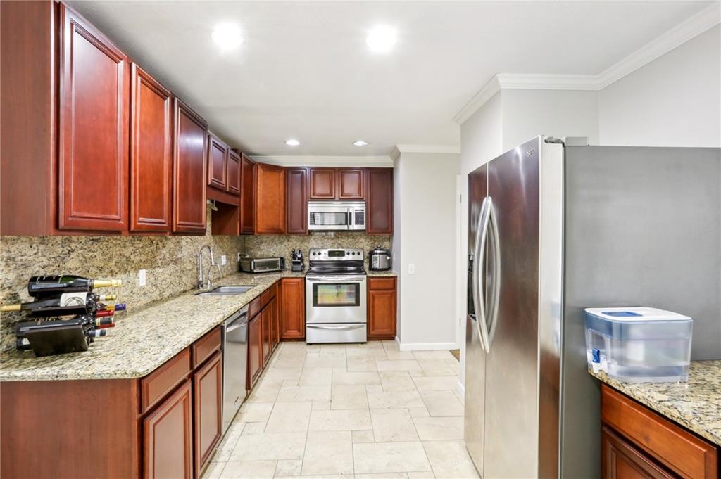 Kitchen with granite and stainless steel appliances.