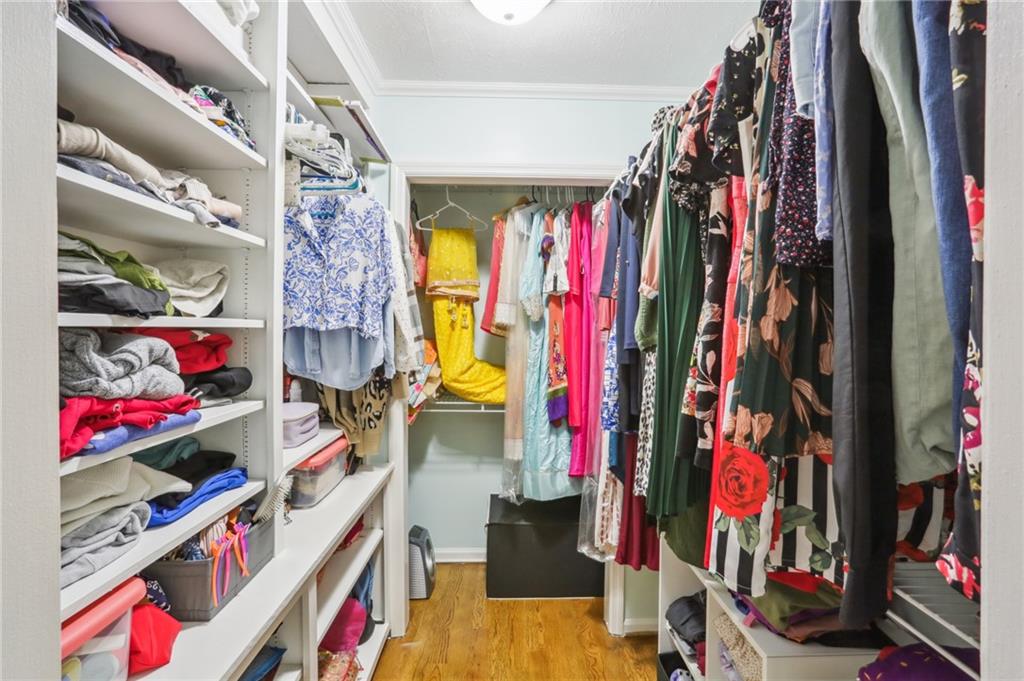 Primary closet with built in shelving.