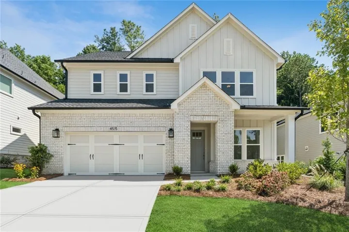 Contemporary two-story exterior with light brick and vertical siding accents
