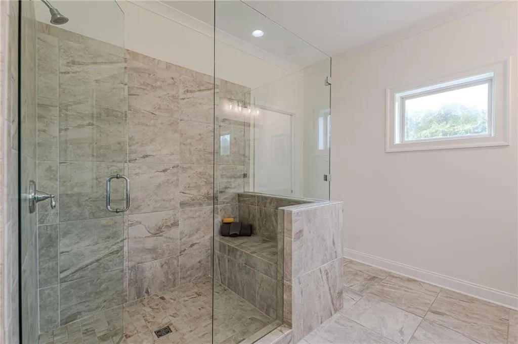 Bathroom with walk in shower and tile patterned flooring