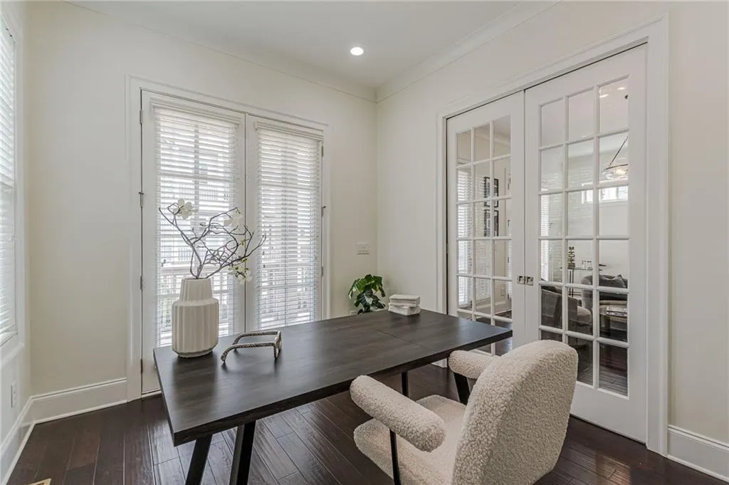Office featuring crown molding, french doors, and dark hardwood / wood-style flooring