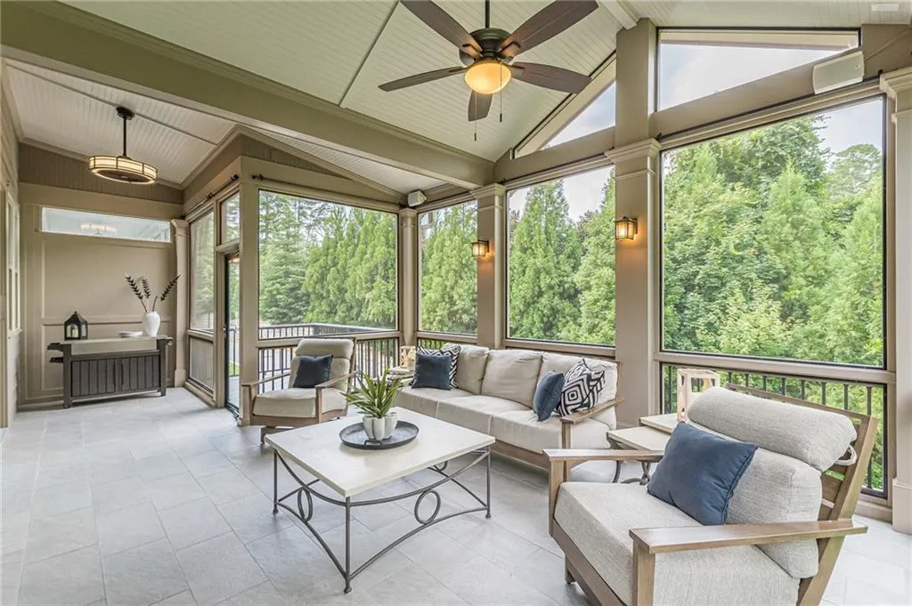 Sunroom featuring plenty of natural light, lofted ceiling, and ceiling fan