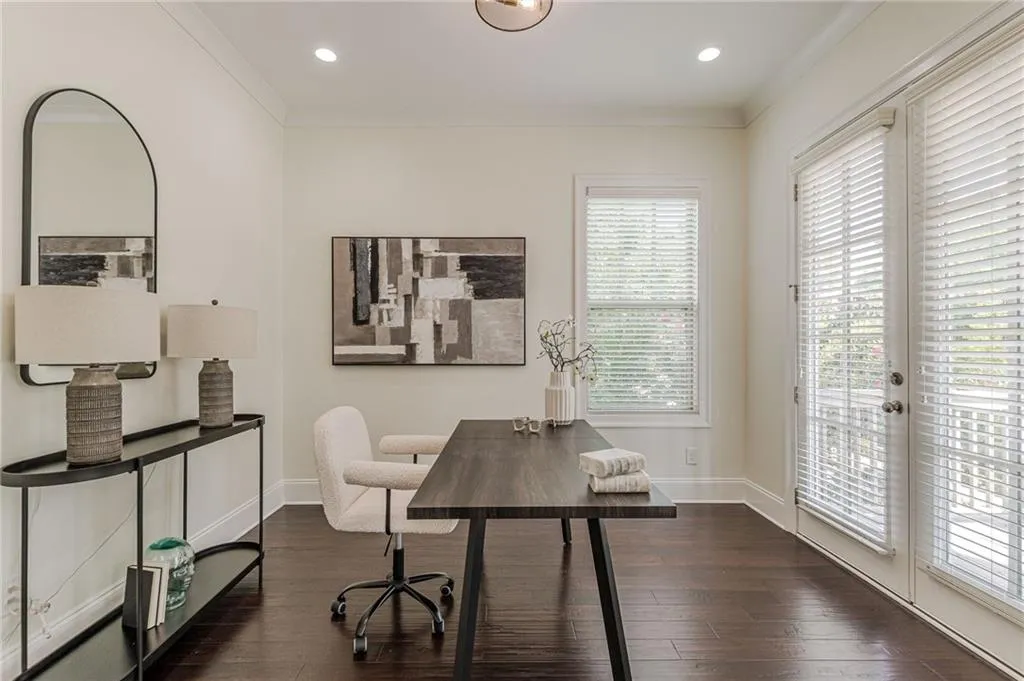 Home office with ornamental molding and dark hardwood / wood-style floors