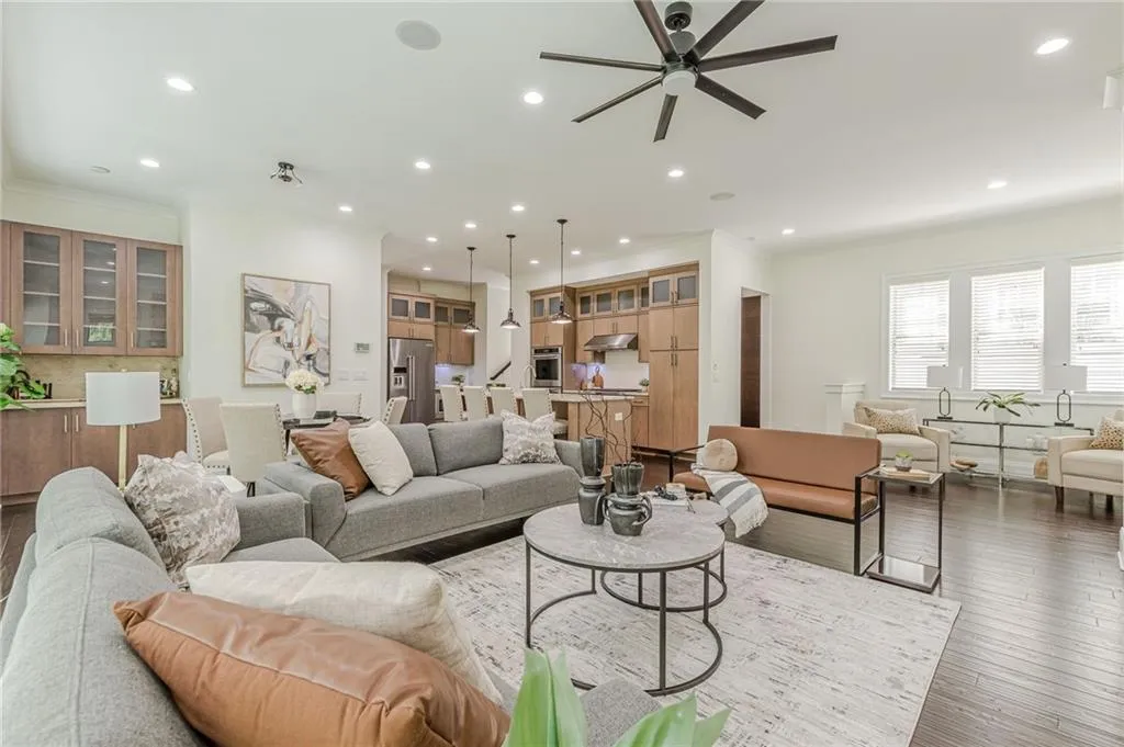 Living room with light hardwood / wood-style flooring and ceiling fan
