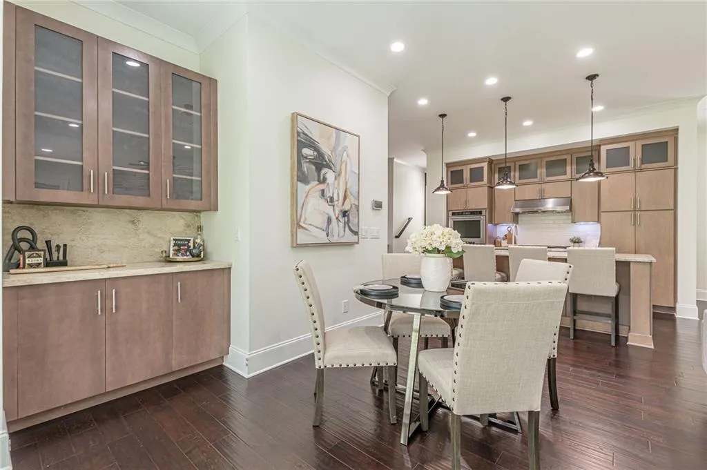 Dining space with crown molding and dark hardwood / wood-style flooring