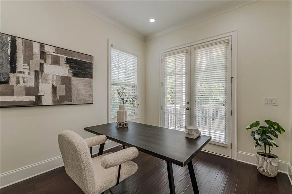 Home office featuring ornamental molding and dark hardwood / wood-style floors