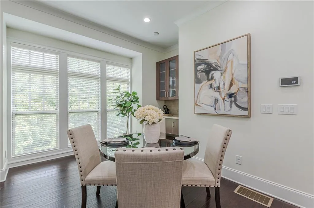 Dining space featuring ornamental molding and dark wood-type flooring