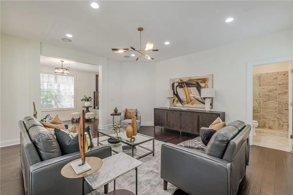 Living room featuring a notable chandelier and dark wood-type flooring