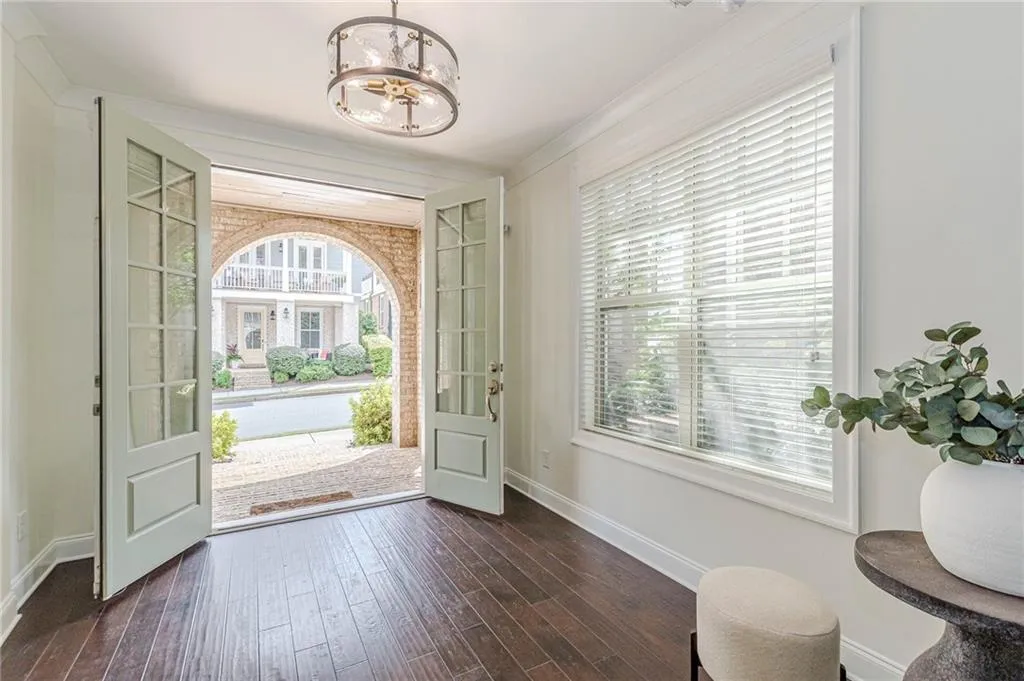 Entrance foyer featuring dark wood-type flooring and an inviting chandelier