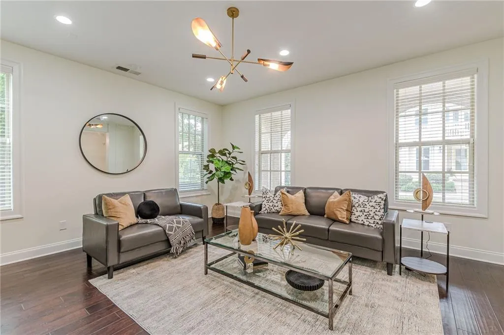 Living room featuring dark hardwood / wood-style floors and a notable chandelier