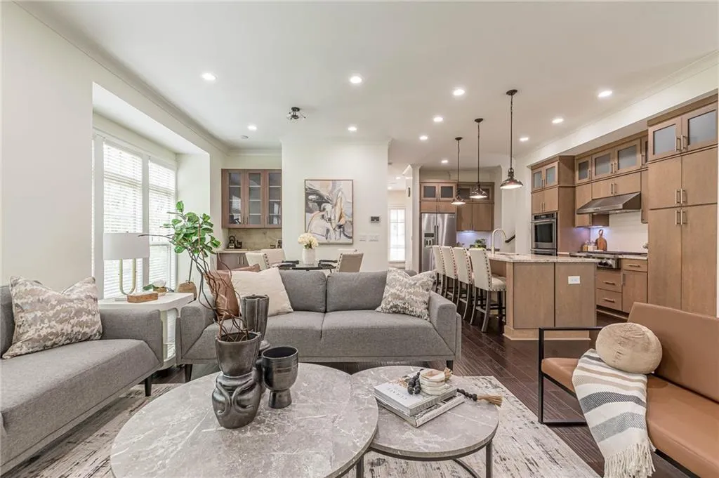 Living room with sink, crown molding, and dark hardwood / wood-style floors