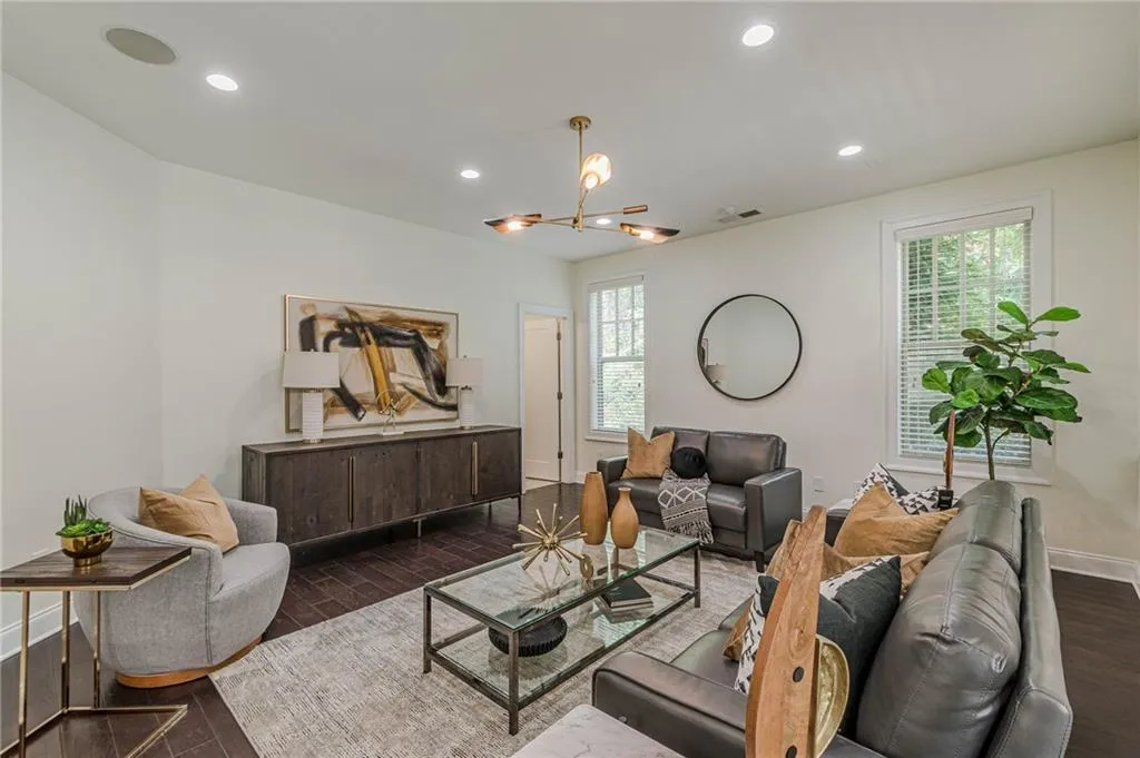 Living room featuring a notable chandelier and dark hardwood / wood-style flooring