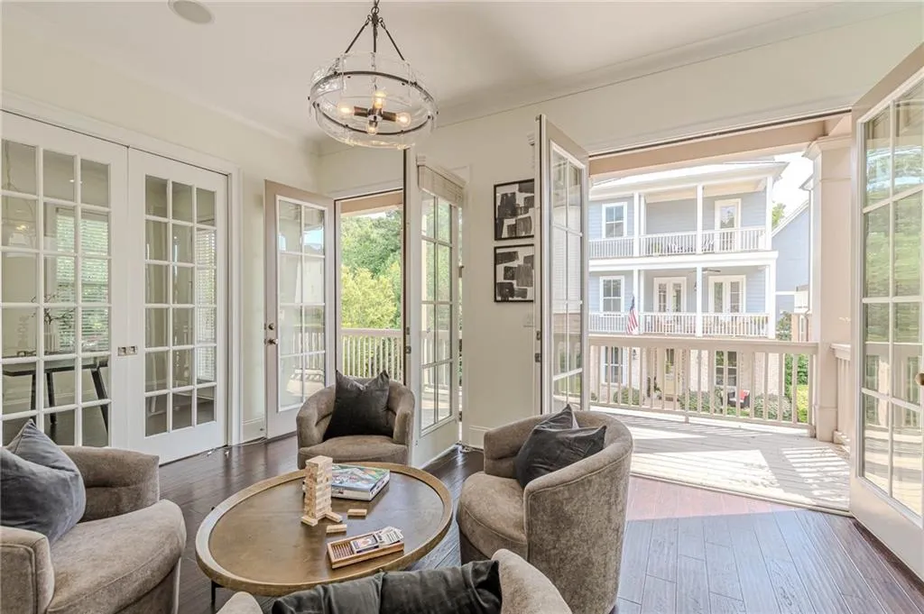 Sunroom with french doors, a chandelier, and plenty of natural light