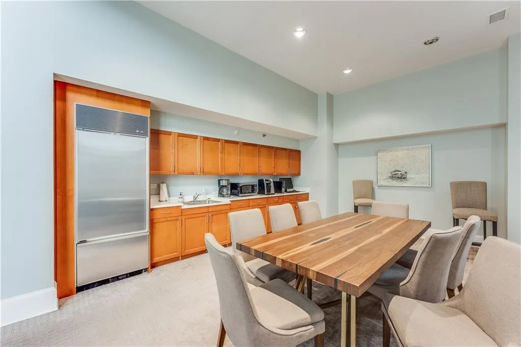 Dining space with recessed lighting, visible vents, a towering ceiling, and light carpet