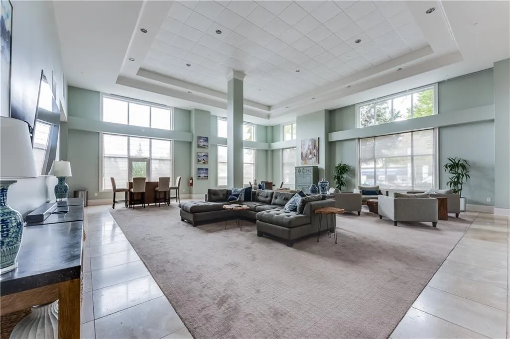 Living area featuring a tray ceiling and a high ceiling
