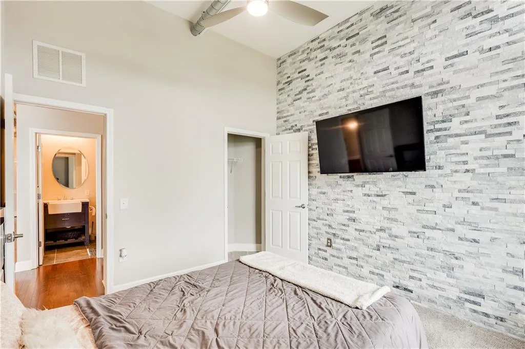 Bedroom with visible vents, wood finished floors, a closet, baseboards, and ceiling fan