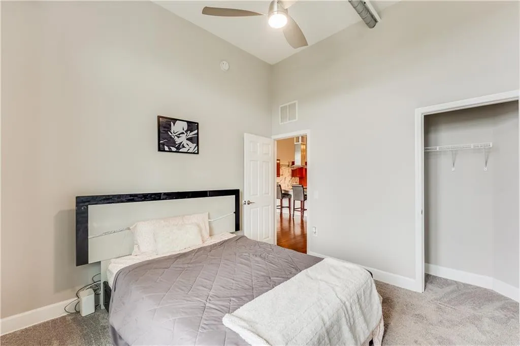 Bedroom featuring carpet, baseboards, visible vents, and a closet