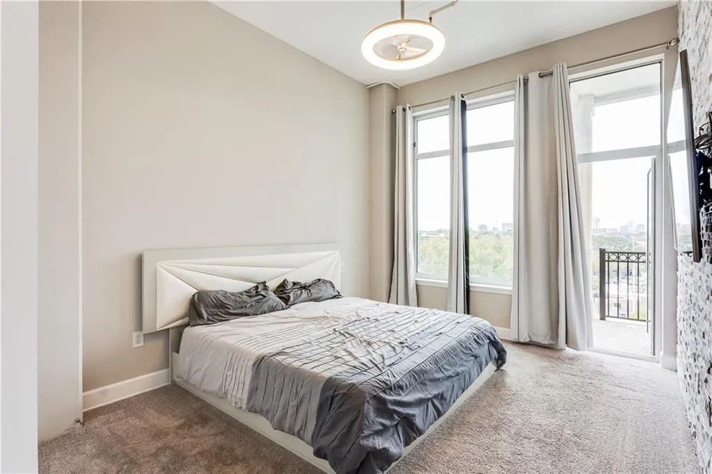 Bedroom featuring baseboards, lofted ceiling, carpet, and access to outside