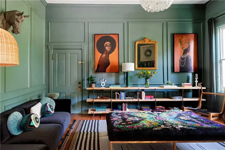 Sitting room with a decorative wall, wood finished floors, and a chandelier