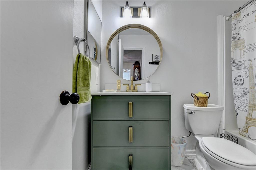 Bathroom with vanity with extensive cabinet space