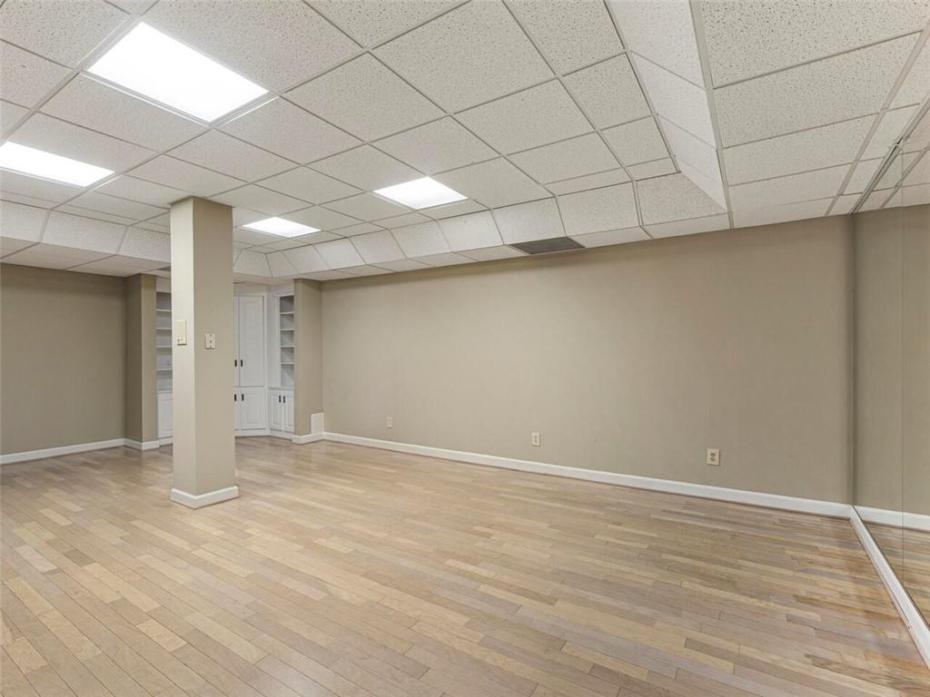 Spacious gym with hatdwood floors and built ins