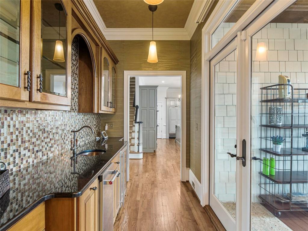Butlers pantry equipped with wine cooler and refrigerator