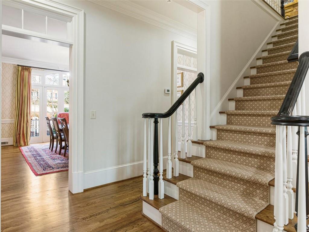 Bac staircase leads to spacious upstairs bedrooms with gleaming hardwood floors