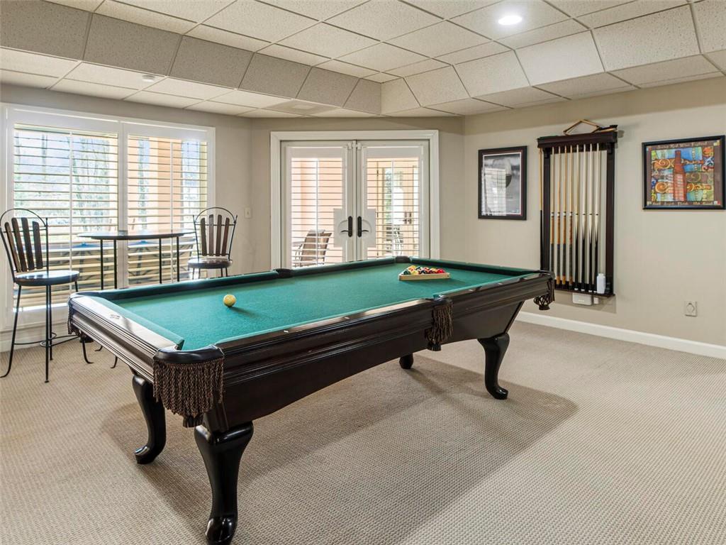 Game room with pool table and French doors leading to outdoor patio entertainment area