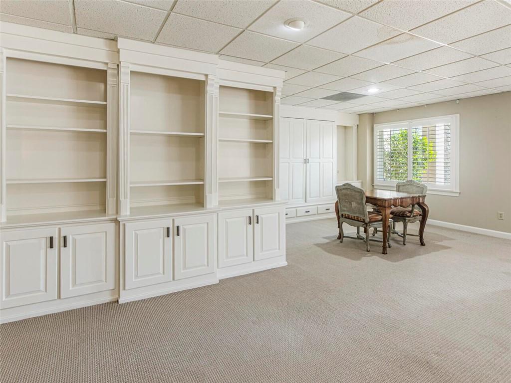 Another view of the lower level family room with custom built ins