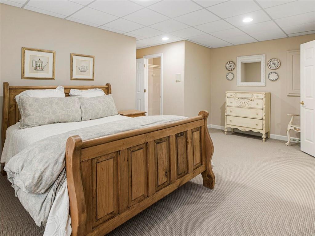 Second spacious lower level bedroom with full bath leading to playroom/hobby room.