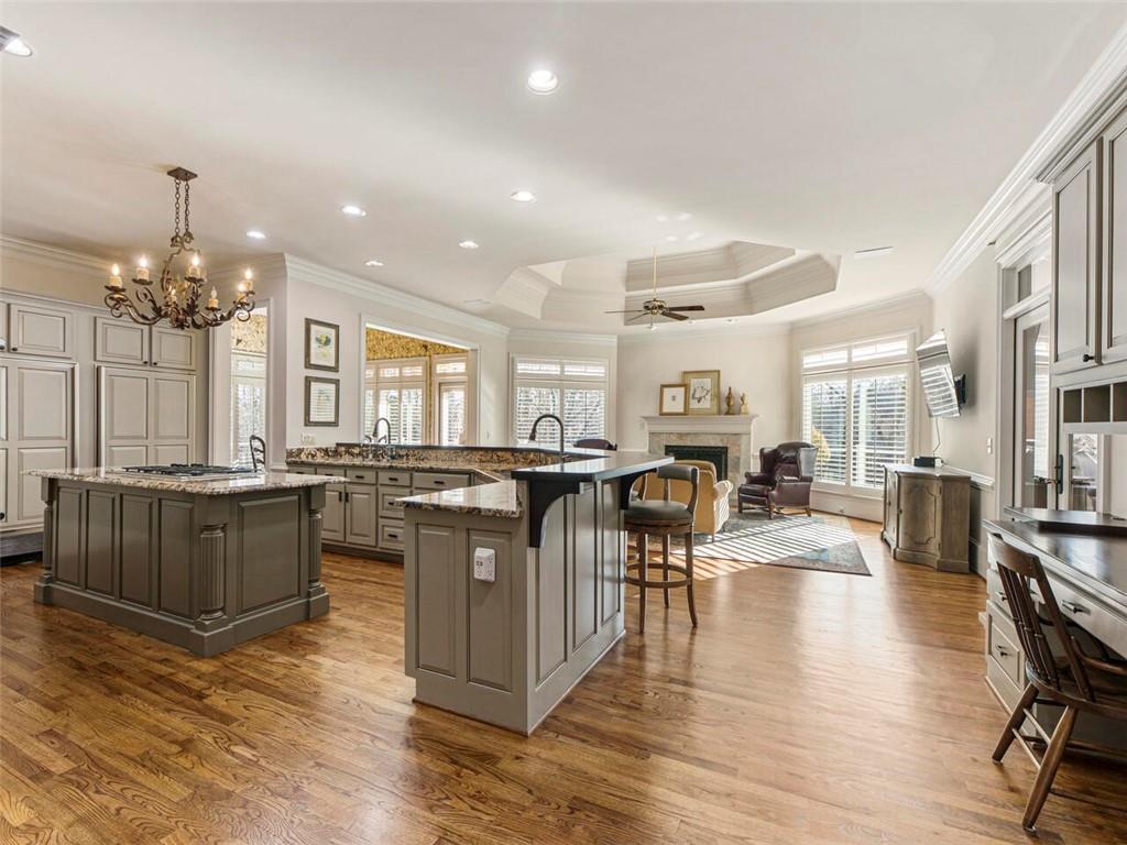 Spacious light filled kitchen with Sub Zero, island, breakfast bar and gas cooktop