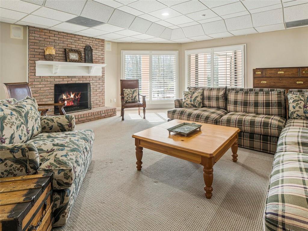 Beautiful brick fireplace gives this spacious area a cozy feel.