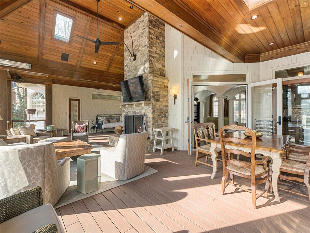 Floor to ceiling stone fireplace, heaters, ceiling fans and skylights make this thoughtfully designed area perfect for year round entertaining.