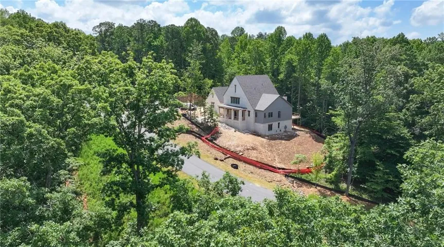 Stately residence set on expansive wooded grounds surrounded by mature trees