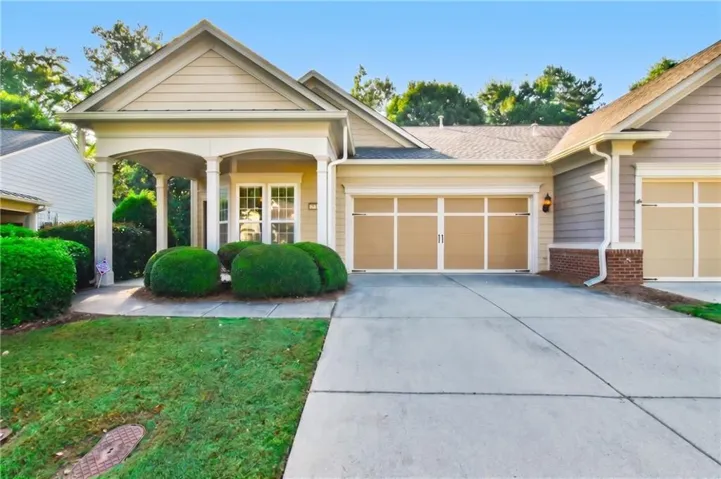Exterior featuring a covered entryway, a two-car garage, and a concrete driveway