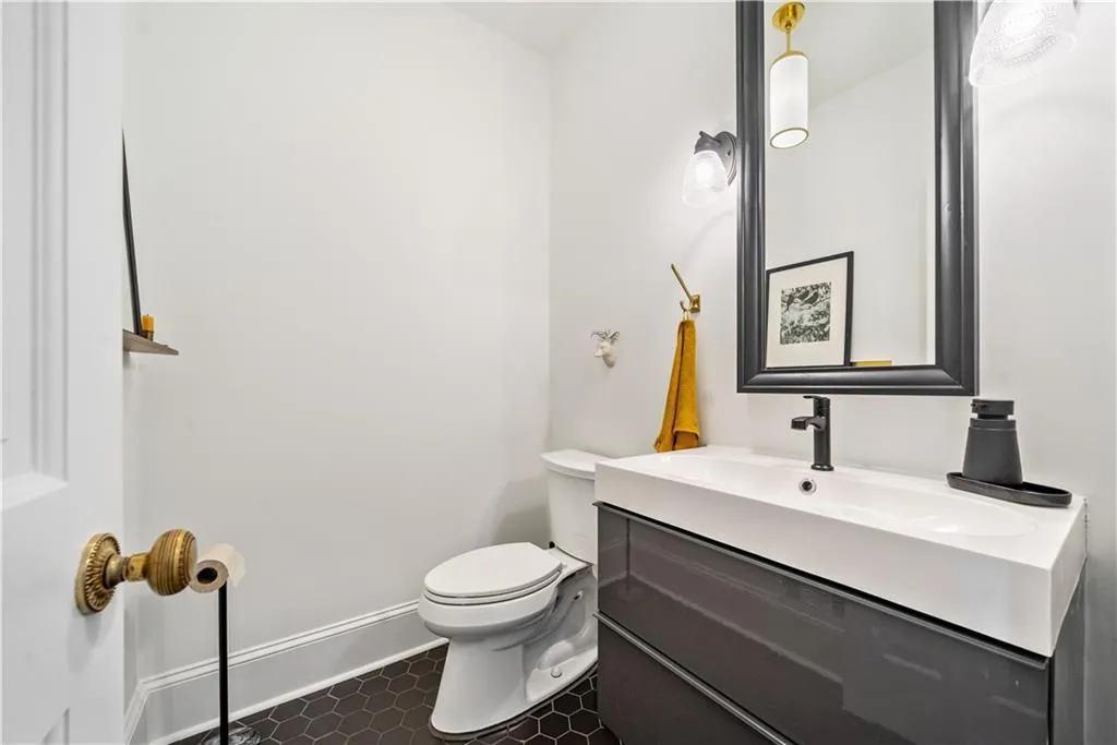 Bathroom with vanity and dark tile patterned floors