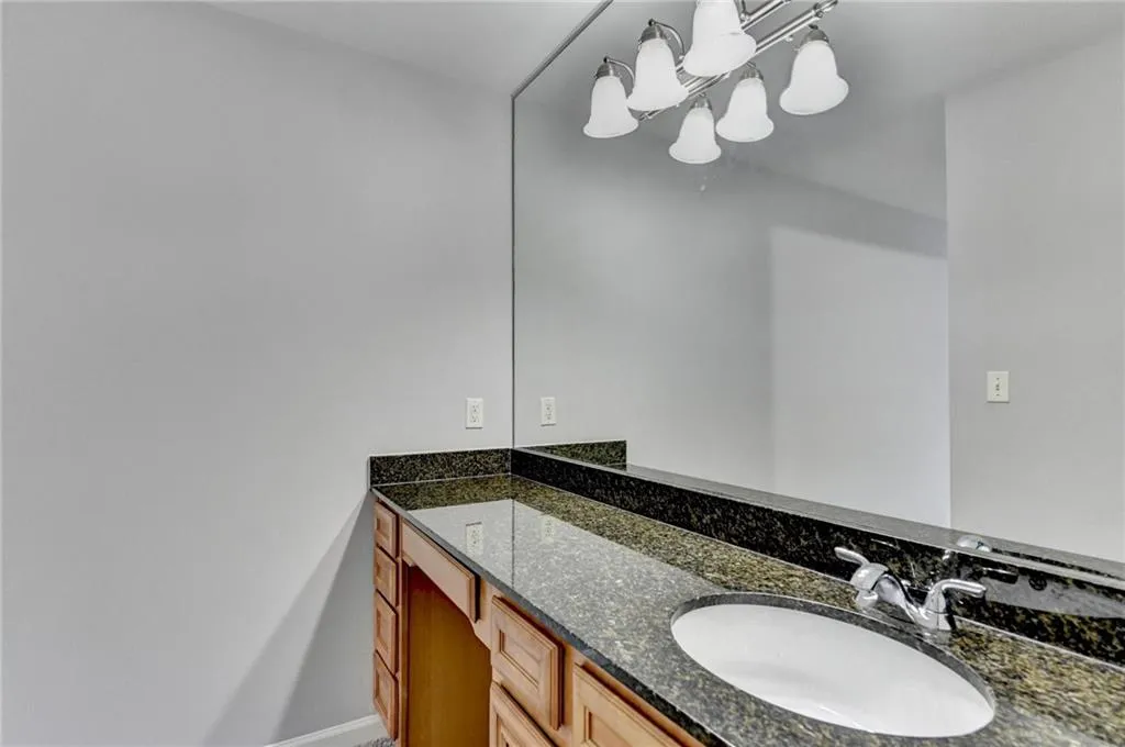 Bathroom with vanity and a chandelier