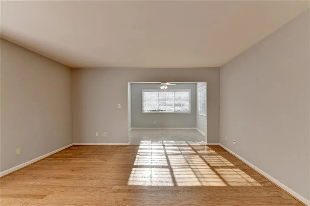 Unfurnished room with light wood finished floors and baseboards