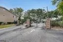 View of asphalt road with a gated entry