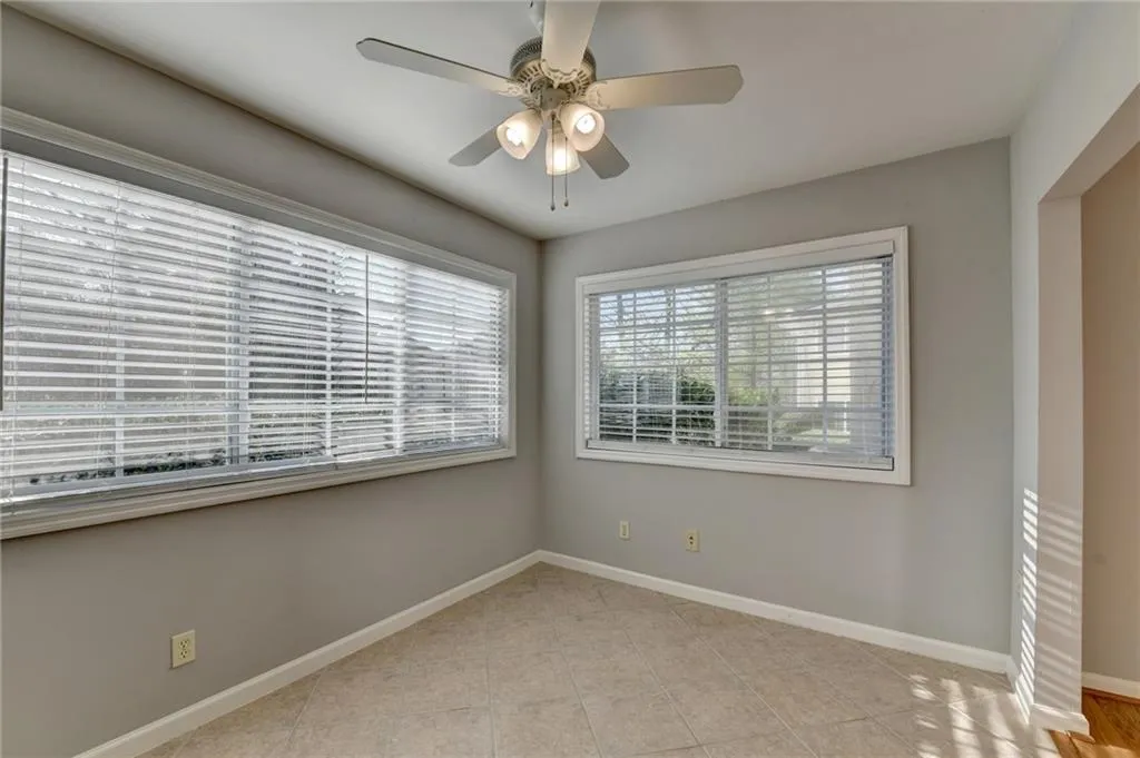 Spare room featuring a ceiling fan and light tile patterned floors