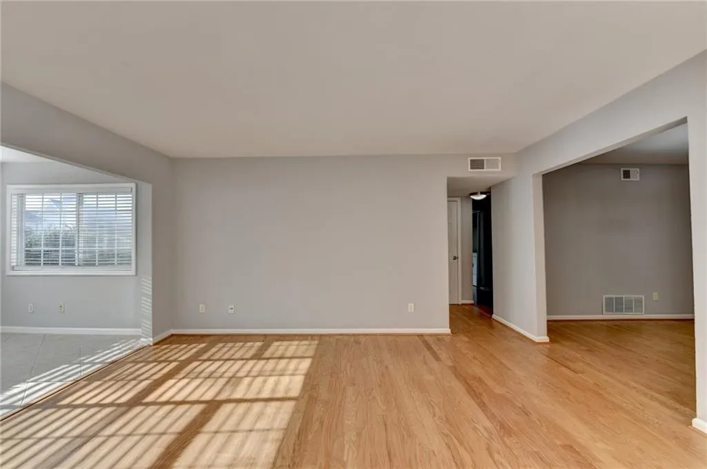 Unfurnished room with light wood-type flooring and baseboards