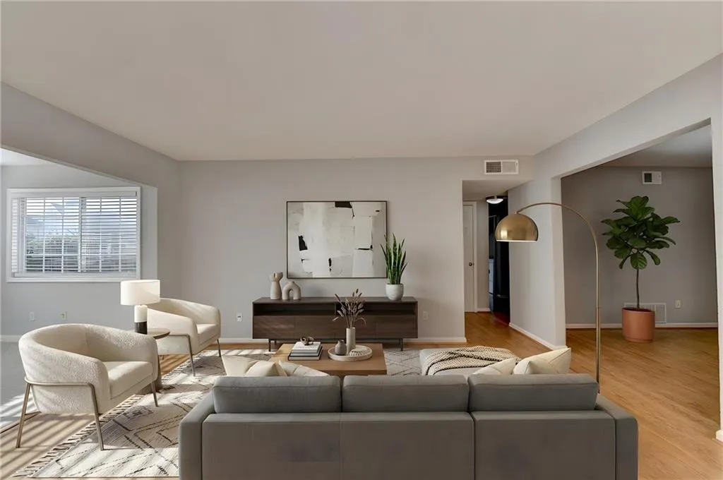 Living area featuring baseboards and light wood finished floors