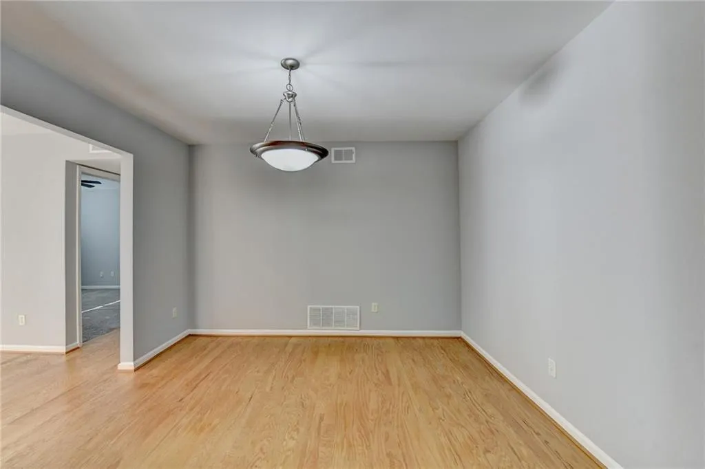 Empty room with light wood finished floors and baseboards