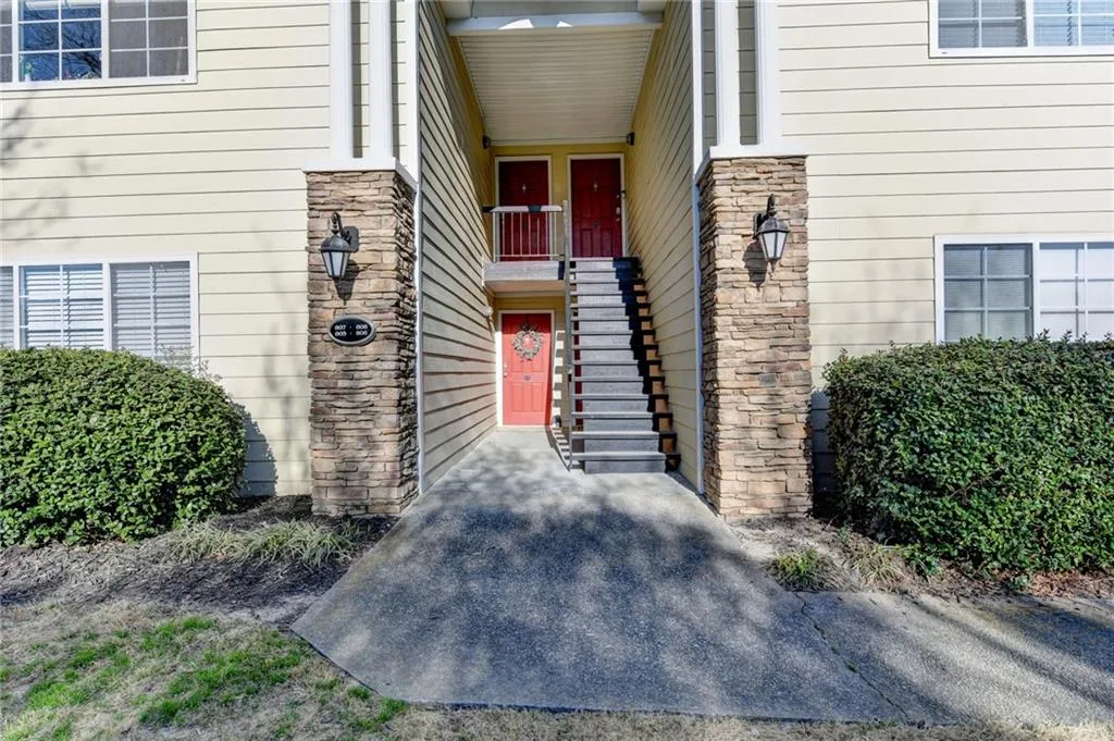 Entrance to property featuring stone siding